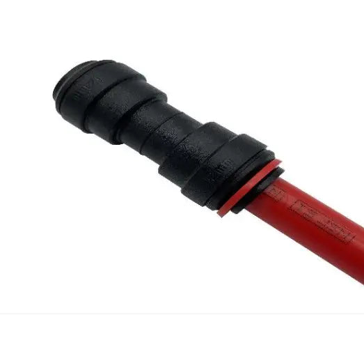Close-up of a black hose fitting on a red hose against a white background