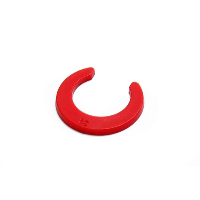 Red metal clip on a white background
