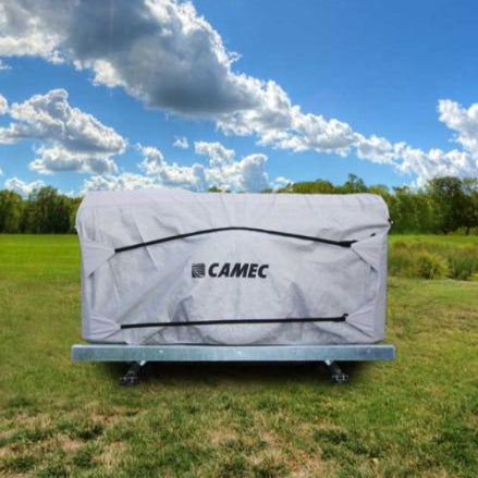A Camec branded camper trailer cover parked on grass with a cloudy sky in the background.