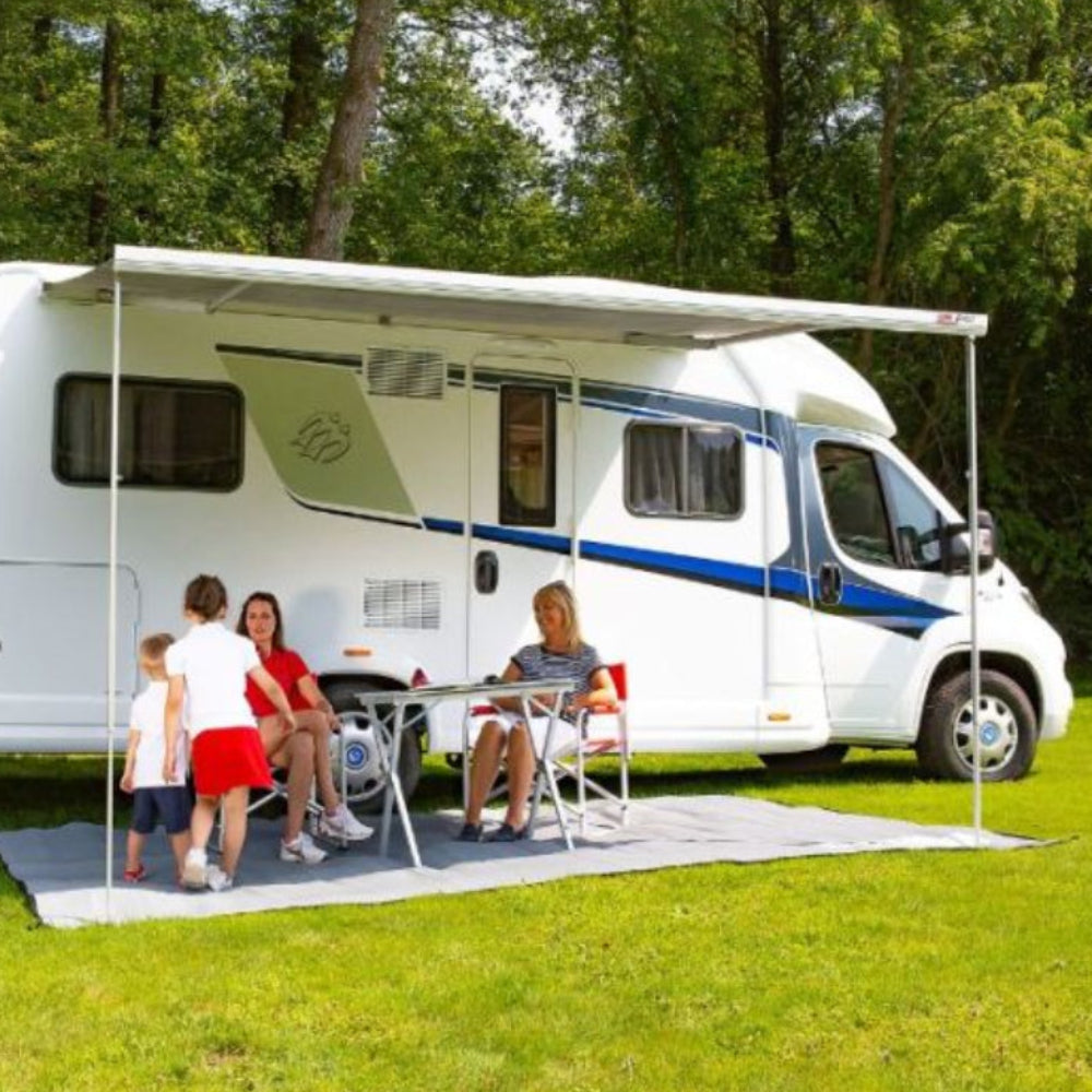 An extended Fiamma F45S 190 awning providing shade over an outdoor seating area beside a campervan.