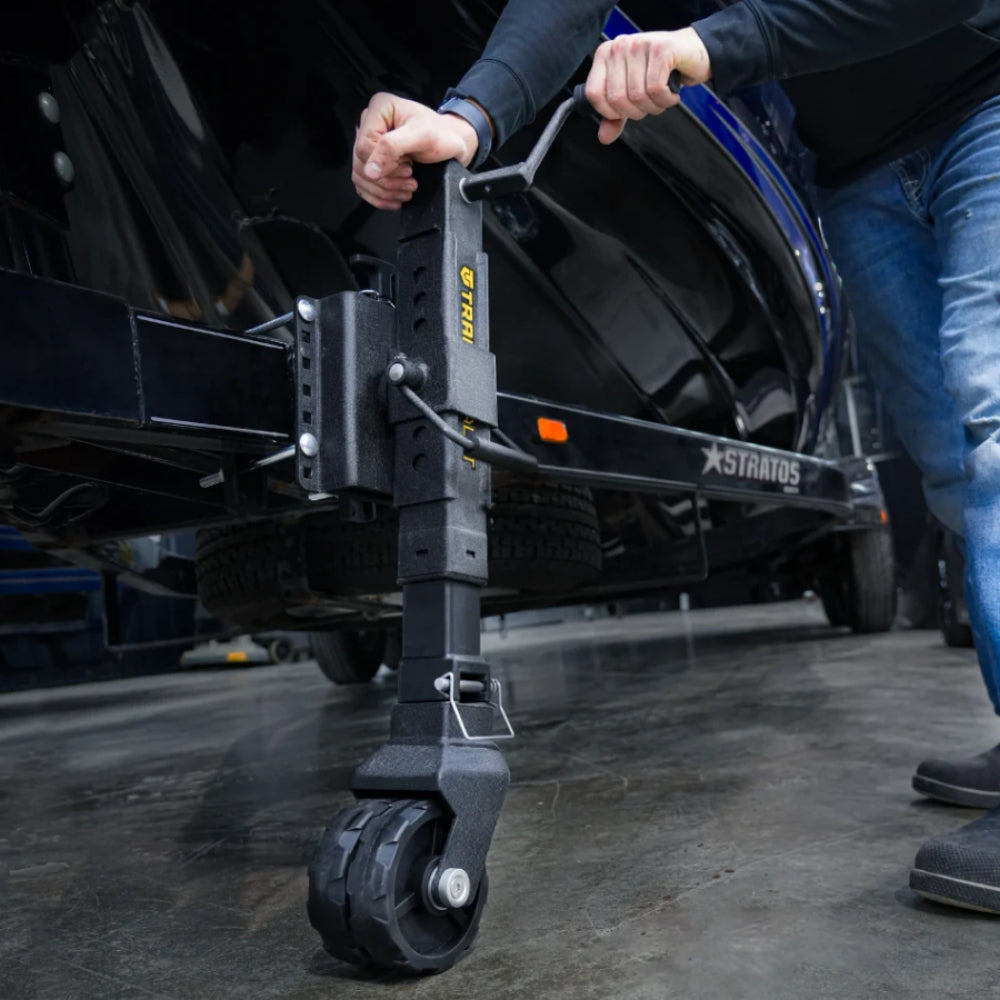 Person using a black vehicle jack to lift a vehicle