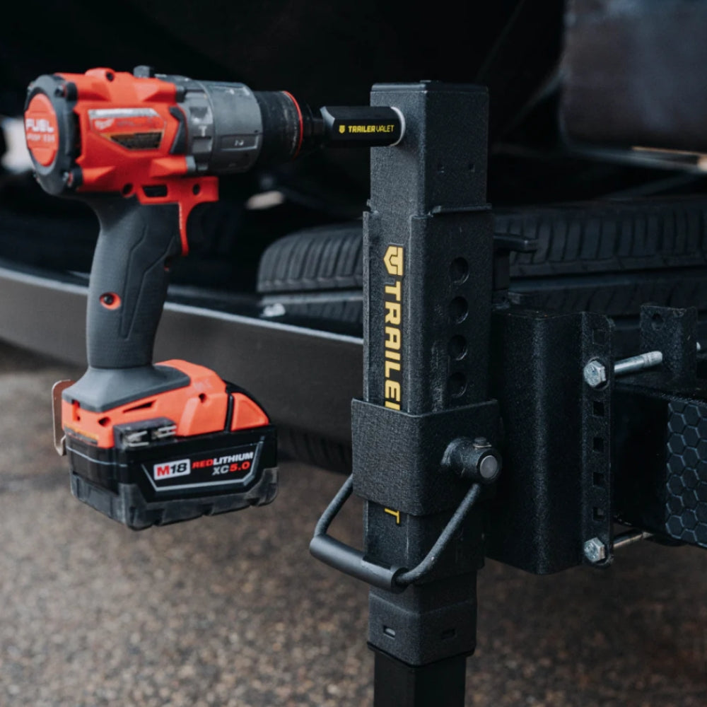 Red and black power drill attached to a black trailer hitch with visible branding.