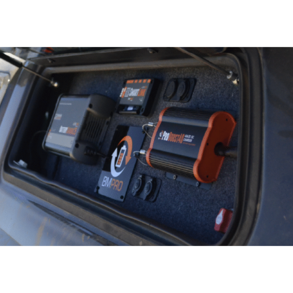 Close-up of electronic devices inside a vehicle's storage compartment.