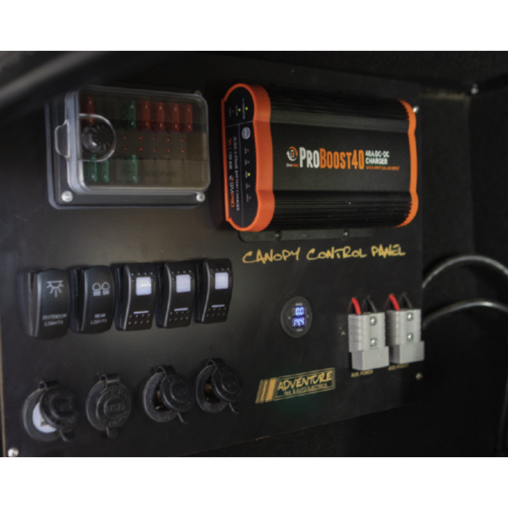Control panel with switches and a ProBoost40 power inverter on a black background