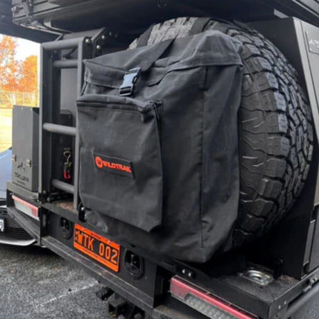 Black tire cover with Wildtrak logo on a vehicle tire