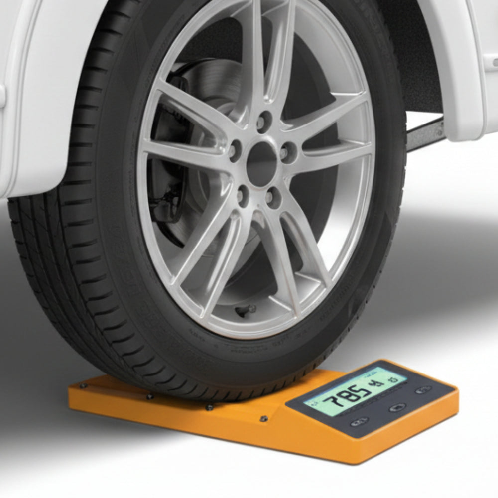 A digital weight scale with a tire positioned on it, indicating that it is designed to measure the weight of vehicle wheels.