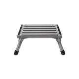 A folded aluminium step with non-skid surface and rubber feet, viewed from a slight angle.