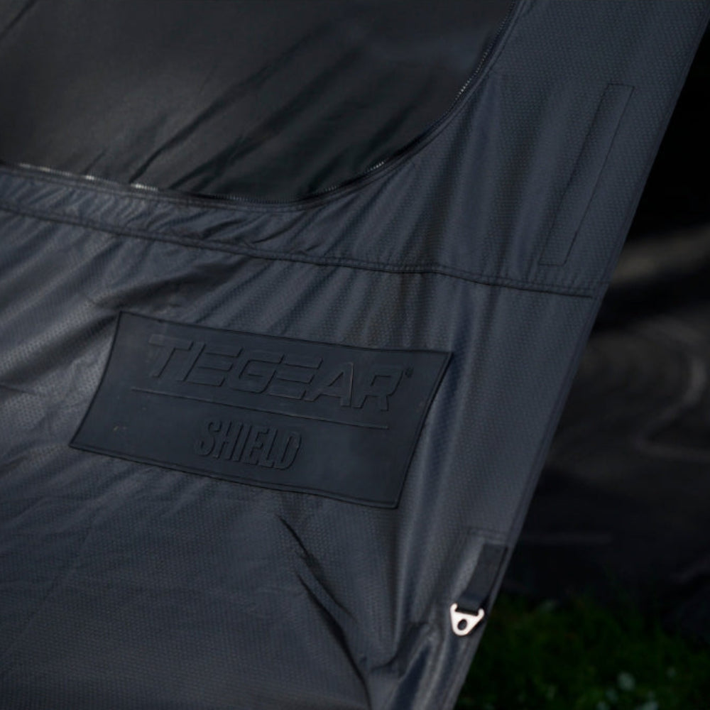 Close-up of Tiegear Shield with a visible brand logo on a dark background