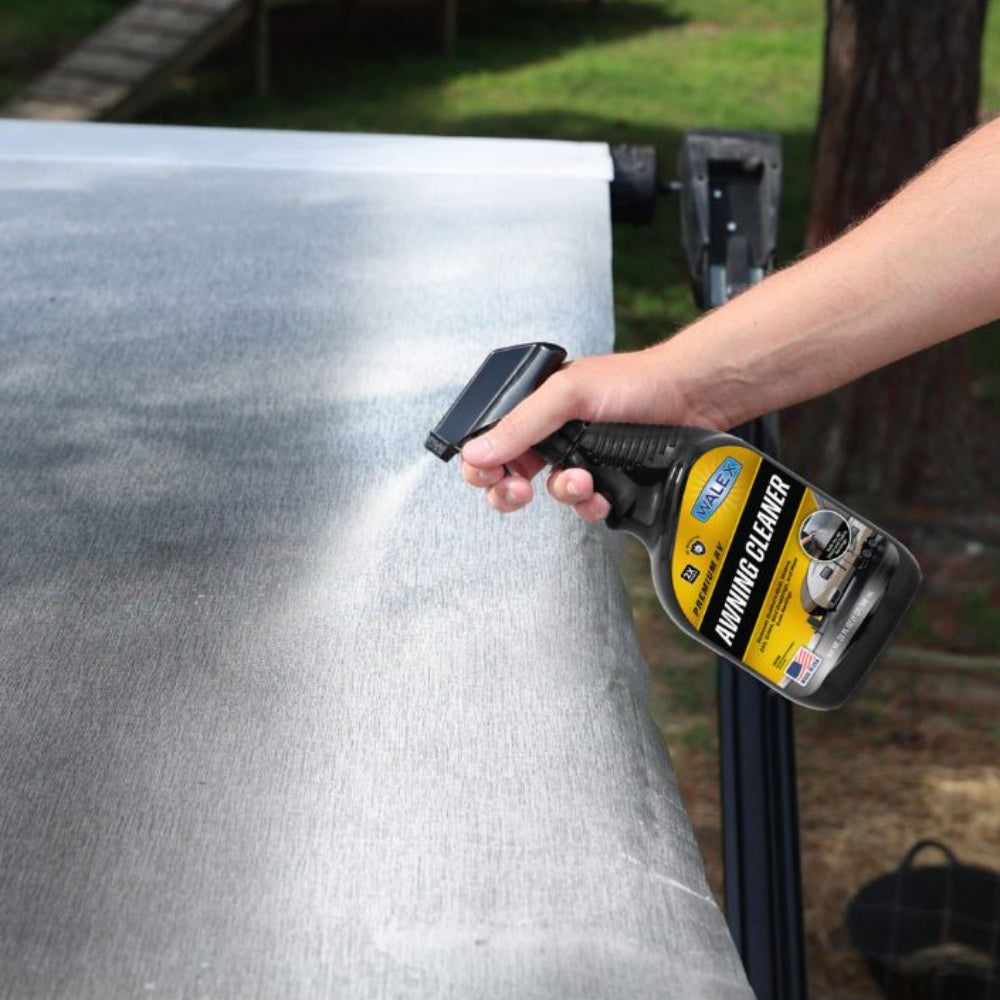 Person using a Walex spray to clean a caravan awning.